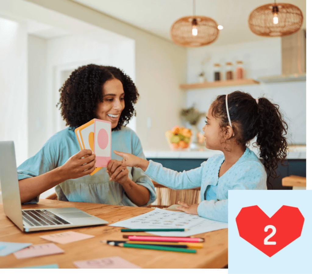 Woman teaching girl with flashcards and laptop